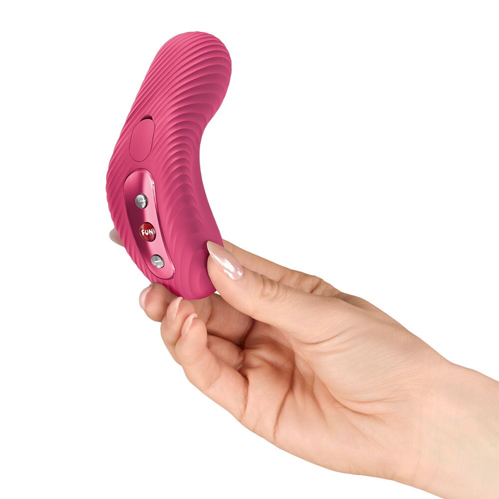 Pinkes Vibrationsgerät mit Bedientasten und Griff, von Hand gehalten