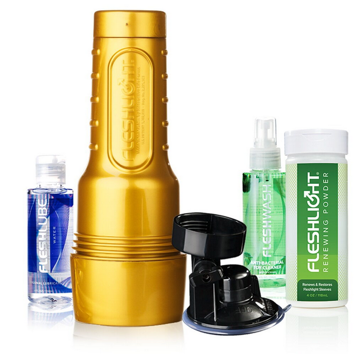 Goldfarbenes Fleshlight STU Trainingsgerät mit schwarzem Aufsatz und Pflegeprodukten