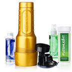 Goldfarbenes Fleshlight STU Trainingsgerät mit schwarzem Aufsatz und Pflegeprodukten